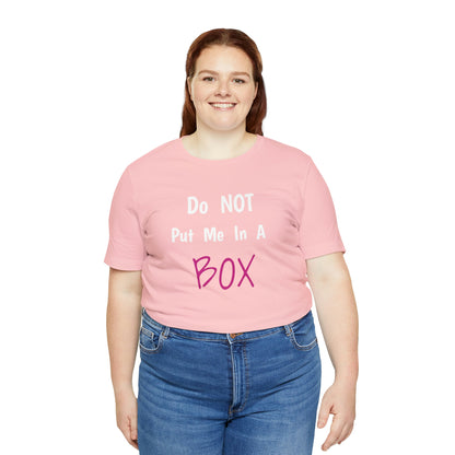 A woman wearing a well-loved favorite pink t-shirt that says DO NOT PUT ME IN A BOX.