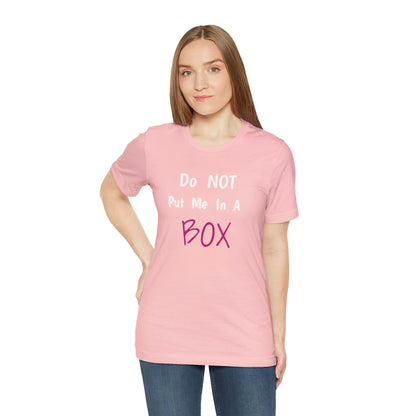 A woman wearing a pink jersey short sleeve tee with a quality print that says DO NOT PUT ME IN A BOX.